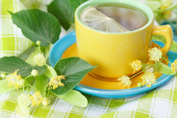 Cup of herbal tea with linden blossoms and lemon