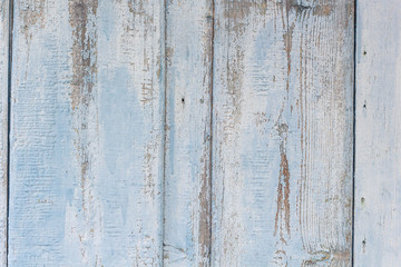 Old wooden background with remains of pieces of scraps of old paint on wood