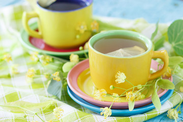 Cups of herbal tea with linden blossoms and lemon