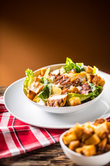 Delicious salad caesar with grilled chicken breast croutons eggs bacon parmesan cheese and  lettuce with dressing