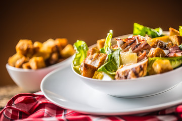 Delicious salad caesar with grilled chicken breast croutons eggs bacon parmesan cheese and  lettuce with dressing