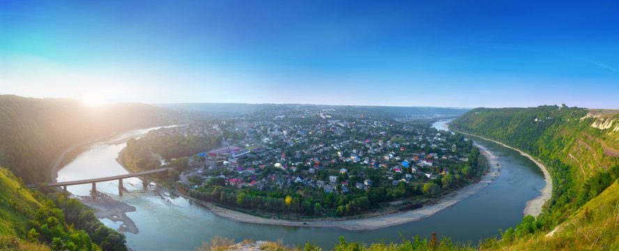 Beautiful evening summer panoramic view of Zalishchyky or Zalischiki, evening view of the town on the bank of the Dniester River meander around city. The province of Bukovina. Ternopil region. Ukraine