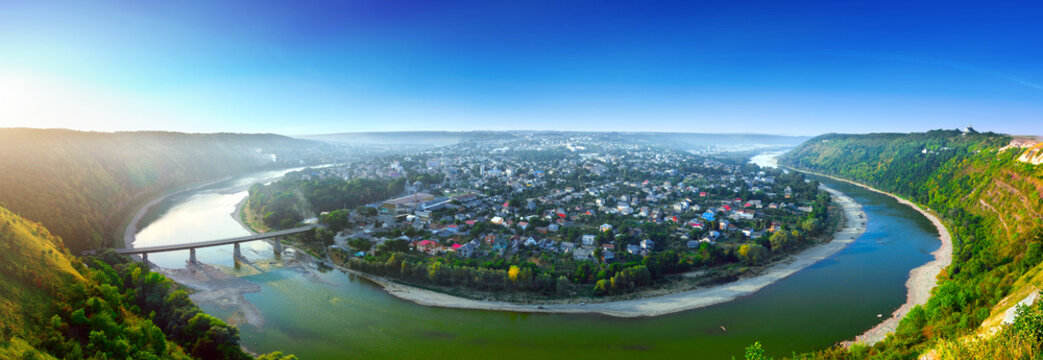 Beautiful evening summer panoramic view of Zalishchyky or Zalischiki, evening view of the town on the bank of the Dniester River meander around city. The province of Bukovina. Ternopil region. Ukraine