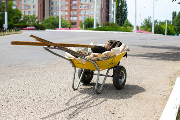 yellow garden wheelbarrow with tools