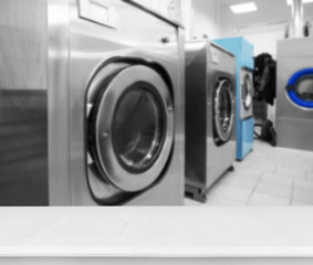 Industrial laundry washing machines in dry cleaner's workshop