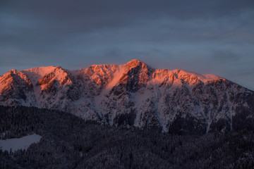 Beautifull cloudy sunrise in the mountains with snow ridge
