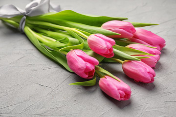 Bouquet of beautiful tulips on grey textured background