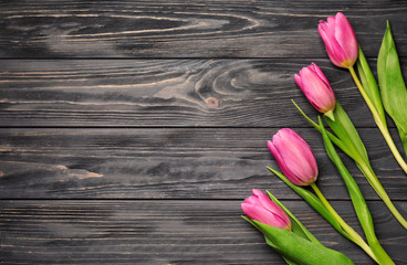 Beautiful fresh tulips on wooden background