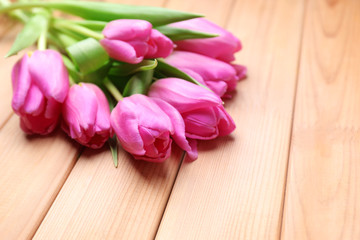 Obraz na płótnie Canvas Beautiful fresh tulips on wooden background