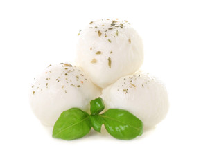 Mozzarella cheese balls and basil on white background