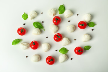 Naklejka na ściany i meble Composition with mozzarella cheese balls, cherry tomatoes and basil on white background