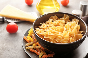 Dishware with uncooked pasta on table