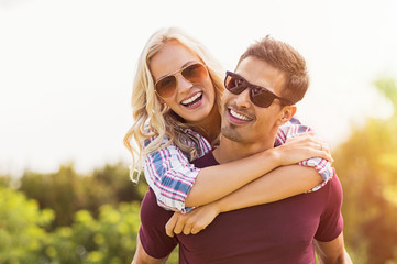 Man giving piggyback ride to woman