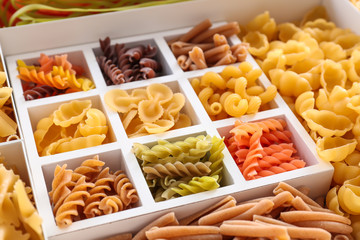 Boxes with different uncooked pasta, closeup