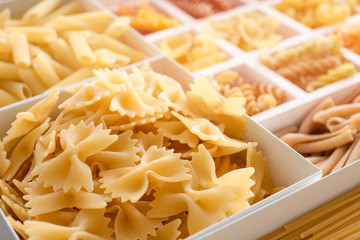 Boxes with different uncooked pasta, closeup
