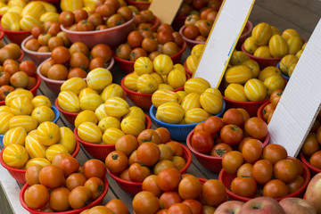 Tomatoes and yellow melons are sold on the street market