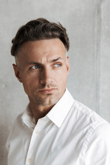 Close up portrait of a concentrated man in white shirt