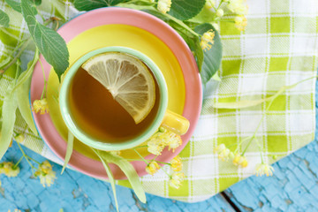 Cup of herbal tea with linden blossoms and lemon