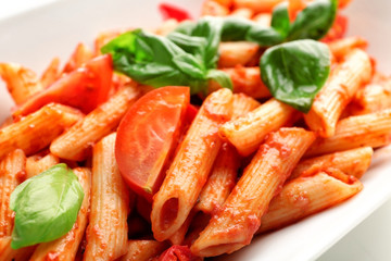 Tasty pasta with tomato sauce on plate, closeup