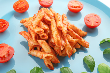 Tasty pasta with tomato sauce on plate, closeup