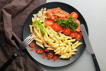 Plate of delicious pasta with bolognese sauce and tomatoes on table