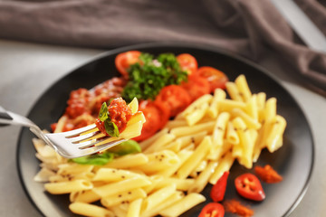 Eating of tasty pasta with bolognese sauce, closeup
