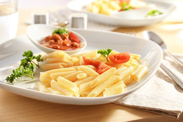 Plate of delicious pasta and bolognese sauce on table, closeup