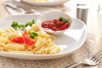 Plate of delicious pasta with bolognese sauce on table, closeup