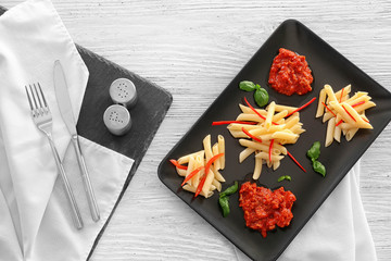 Plate of delicious pasta with bolognese sauce on table, top view
