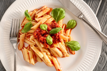 Plate of delicious pasta with bolognese sauce on table, closeup