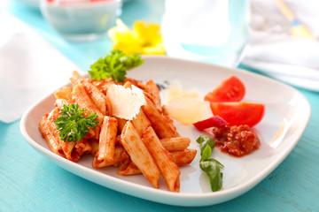 Plate of delicious pasta with bolognese sauce on table