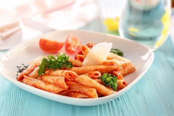 Plate of delicious pasta with bolognese sauce on table