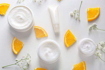 Flat lay composition with skin care cosmetics on white background