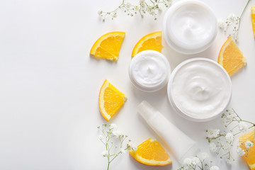 Flat lay composition with skin care cosmetics on white background
