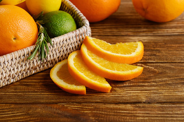 Tray with ripe citrus fruits on wooden background