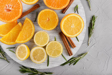 Ripe citrus fruits on wooden board