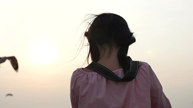Beautiful Asian girl taking pictures outdoors slow motion 