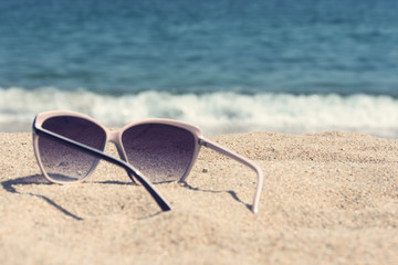 Fototapeta na wymiar glasses on the beach sand