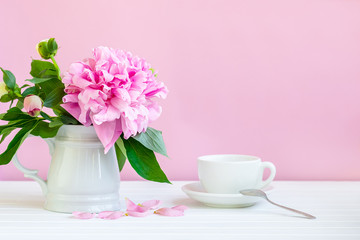 A cup of tea and peonies