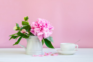 A cup of tea and peonies