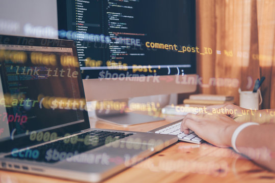 Programmer hands Working at home with computer. Man writing a code. Men programmer hands on the keyboard. Hand coding and showing code graphic on screen. Web Design Business Concep