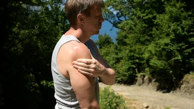 Pain in the shoulder. A man is doing a massage. Problems with joints. 