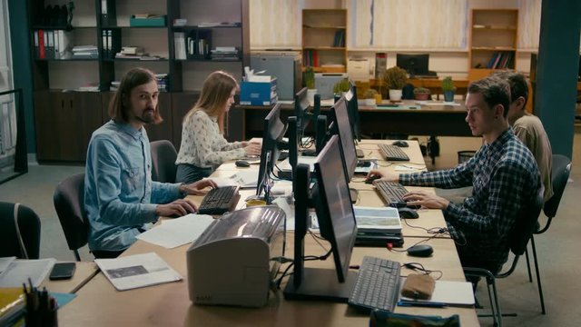 Young Casual Teamwork is Working at the Computers in the Busy Office