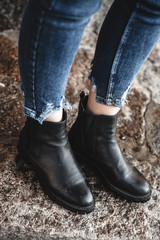 women's shoes and jeans on the beach in the sand