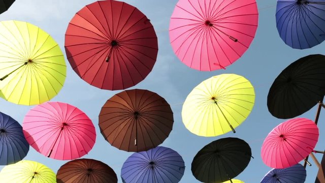 A lot of colored umbrellas against the sky.
