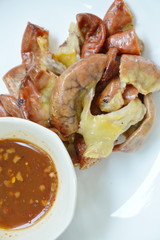 roasted pork fillet slice with spicy sauce on plate
