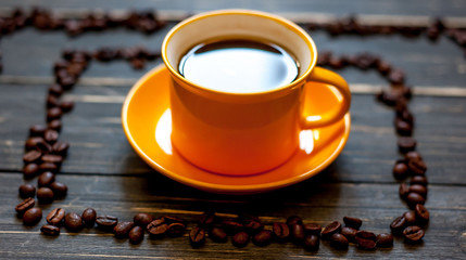 Coffee on a wooden table with scattered grains