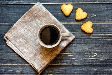coffee on a wooden table with cookies hearts