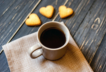 coffee on a wooden table with cookies hearts