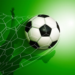 Football  soccer ball flying into the goal net with a player silhouette on background